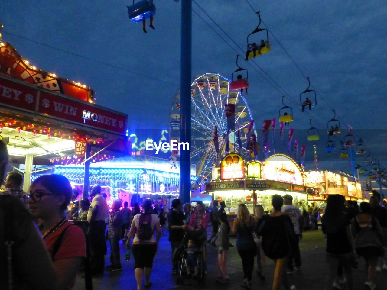 PEOPLE AT AMUSEMENT PARK AT NIGHT