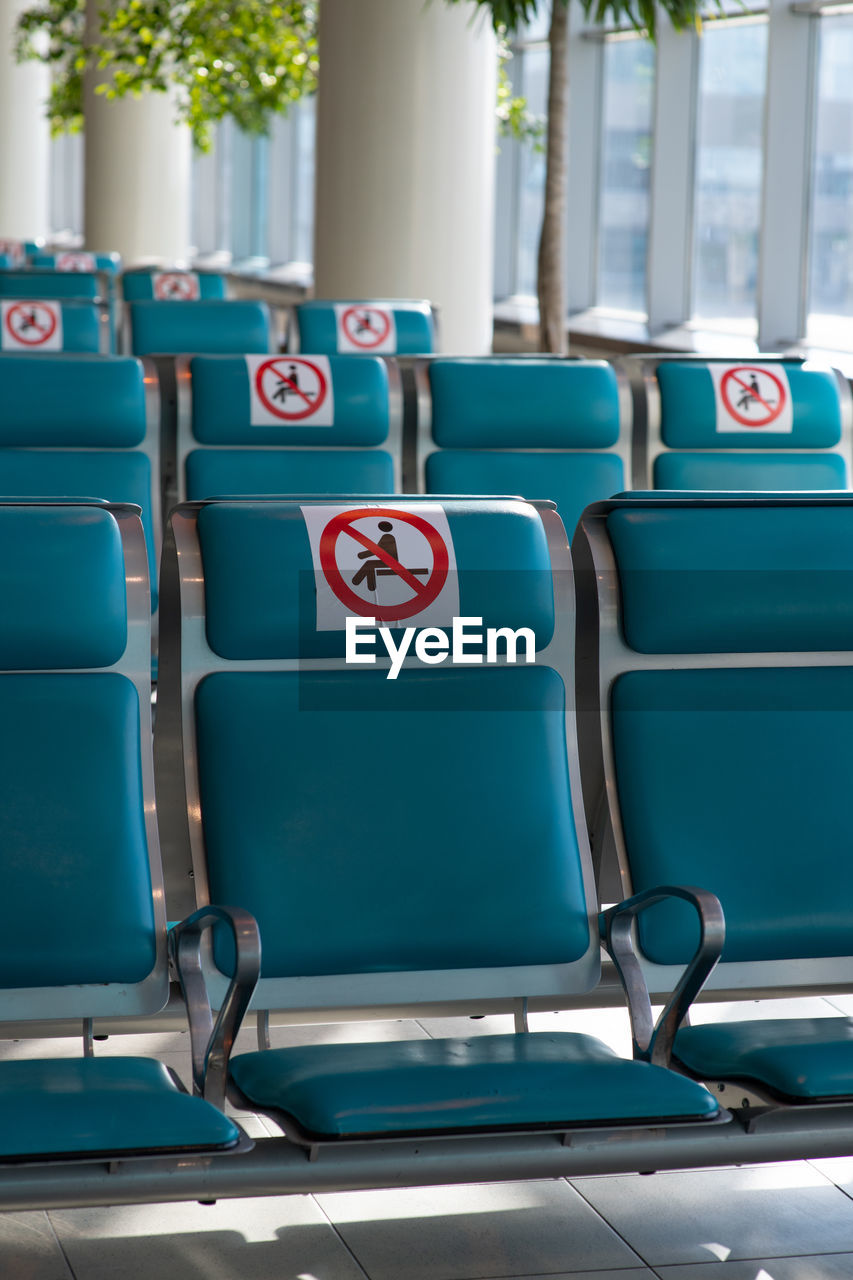 Close-up of blue seats in row outdoors