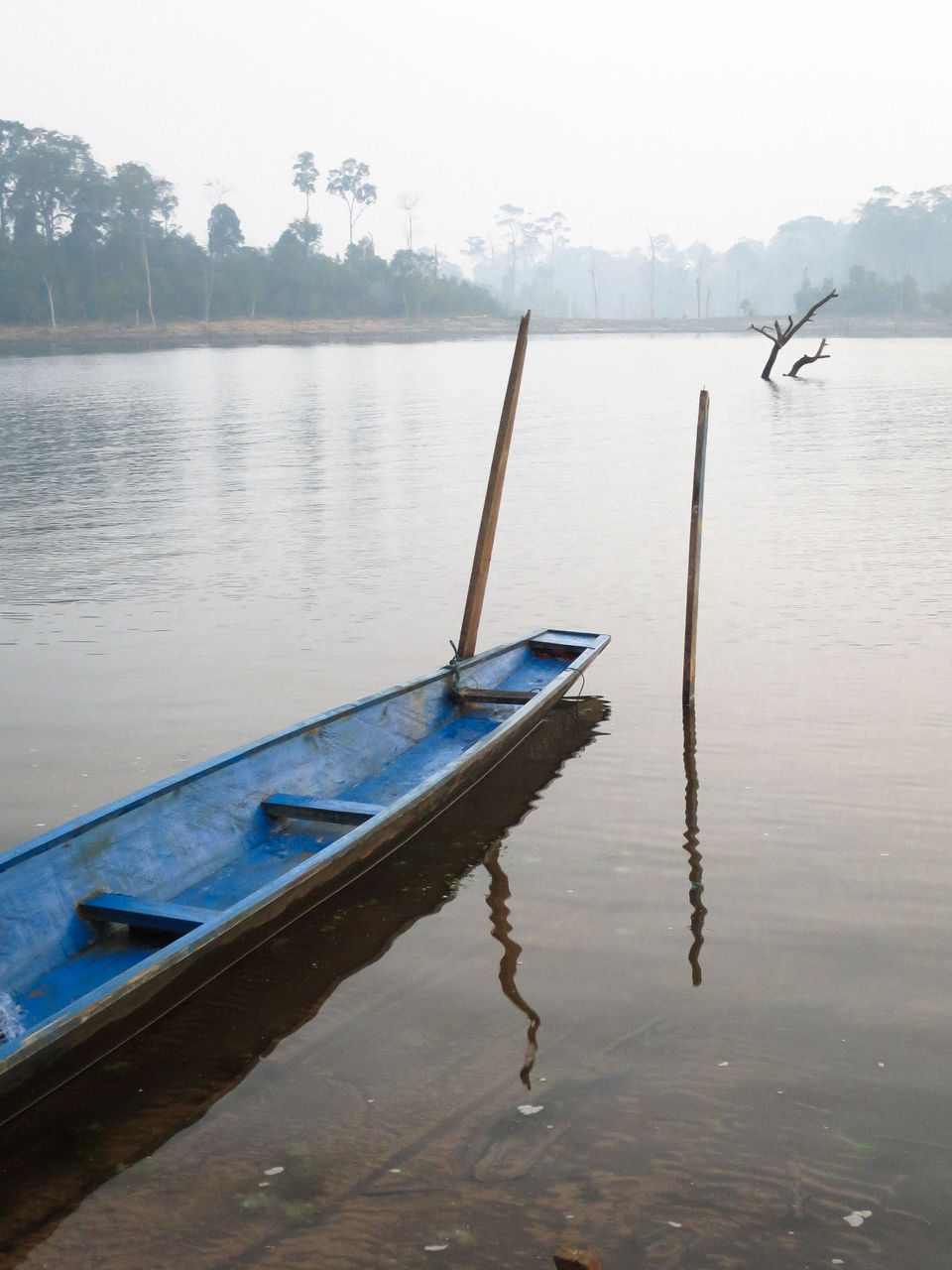 Boat in lake against sky