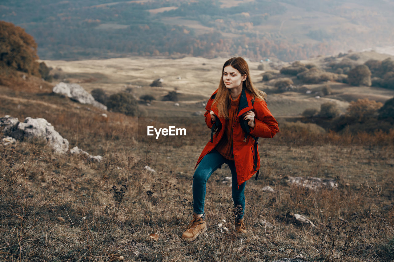 Full length of young woman standing on land