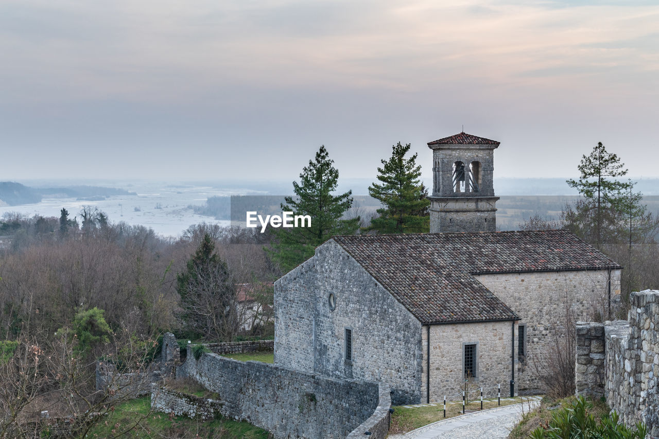 Sunset on the ancient castle of ragogna, italy. fortress guarding the ford on the river tagliamento