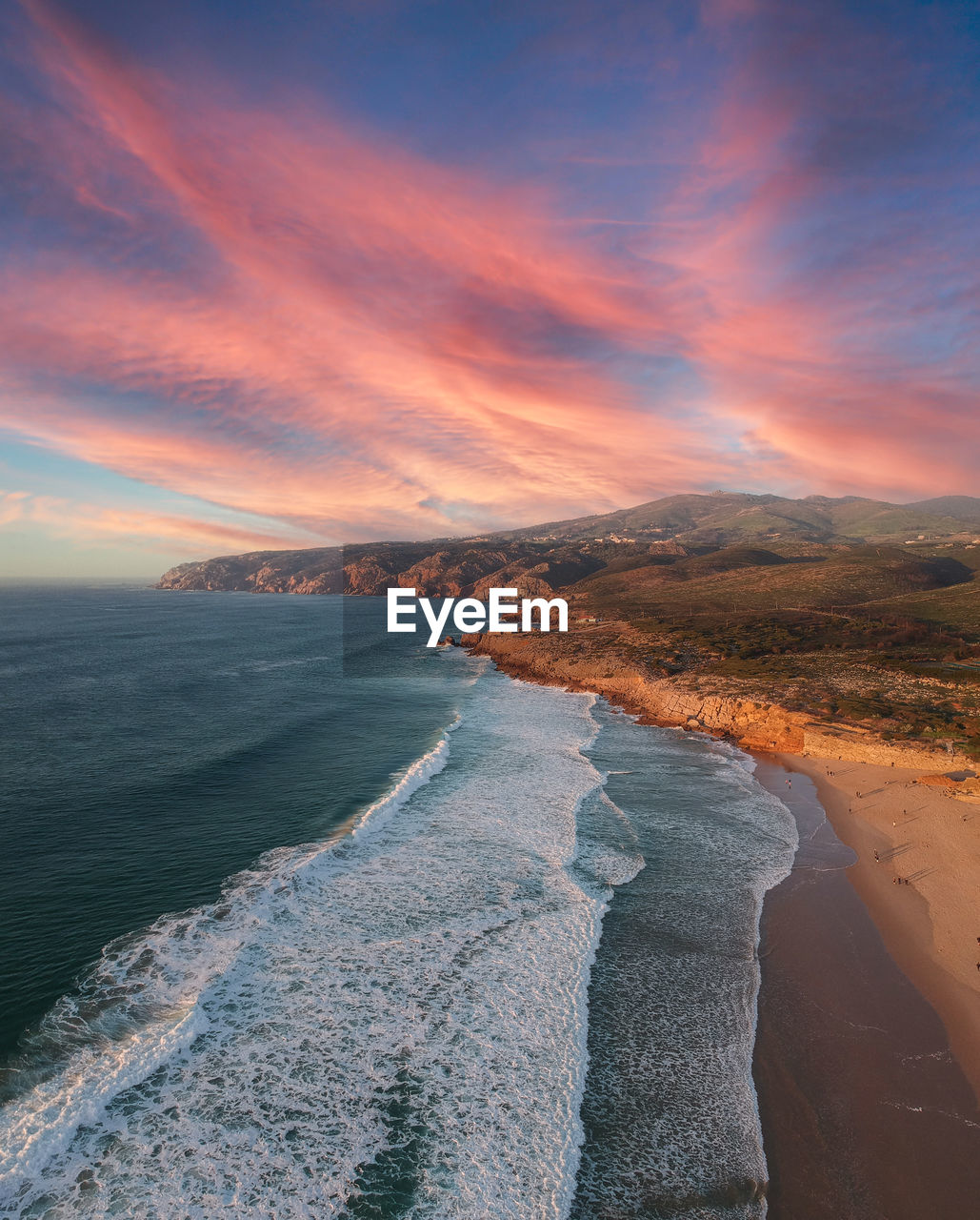 Scenic view of beach against sky during sunset