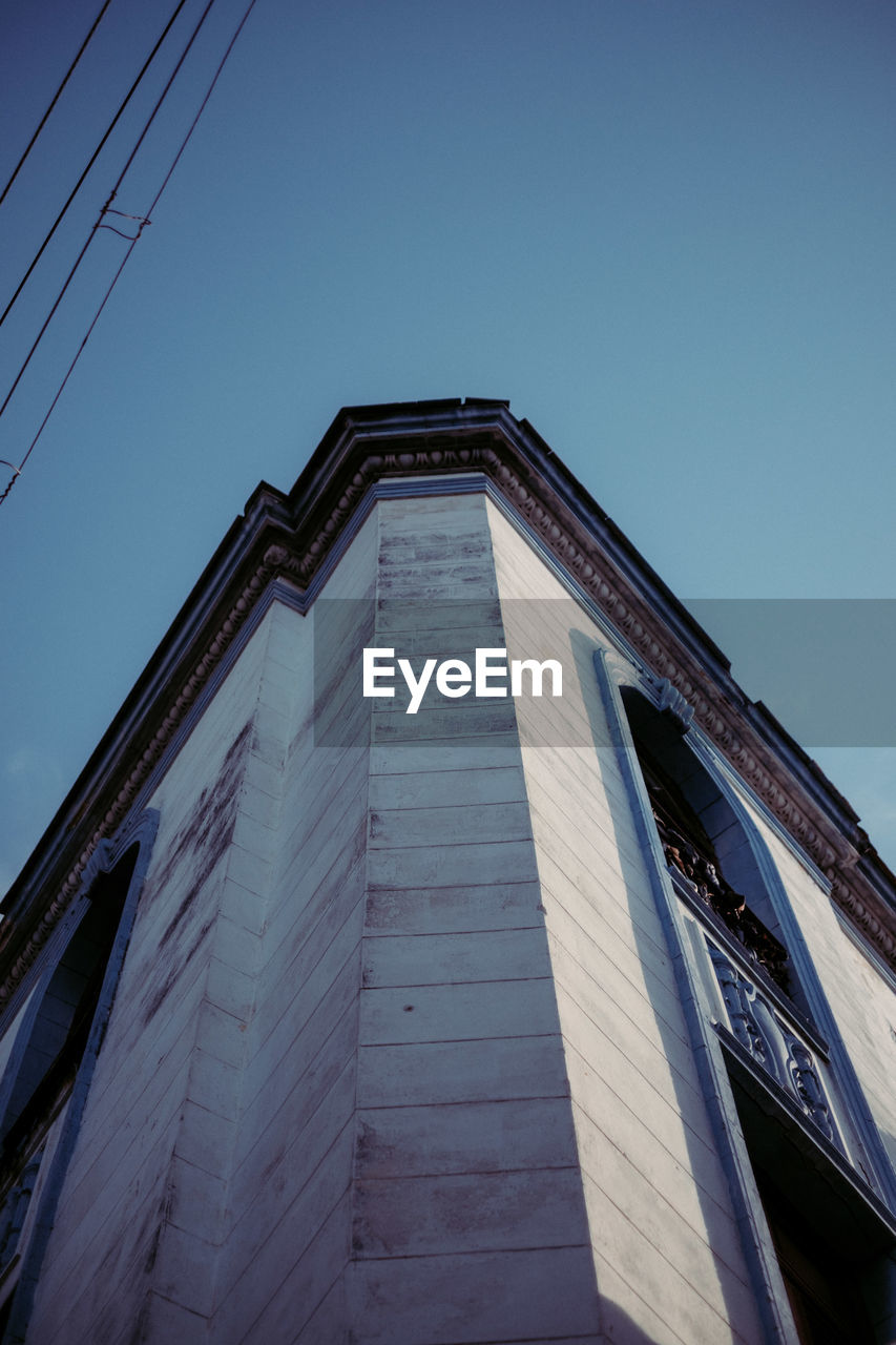 Low angle view of building against clear blue sky