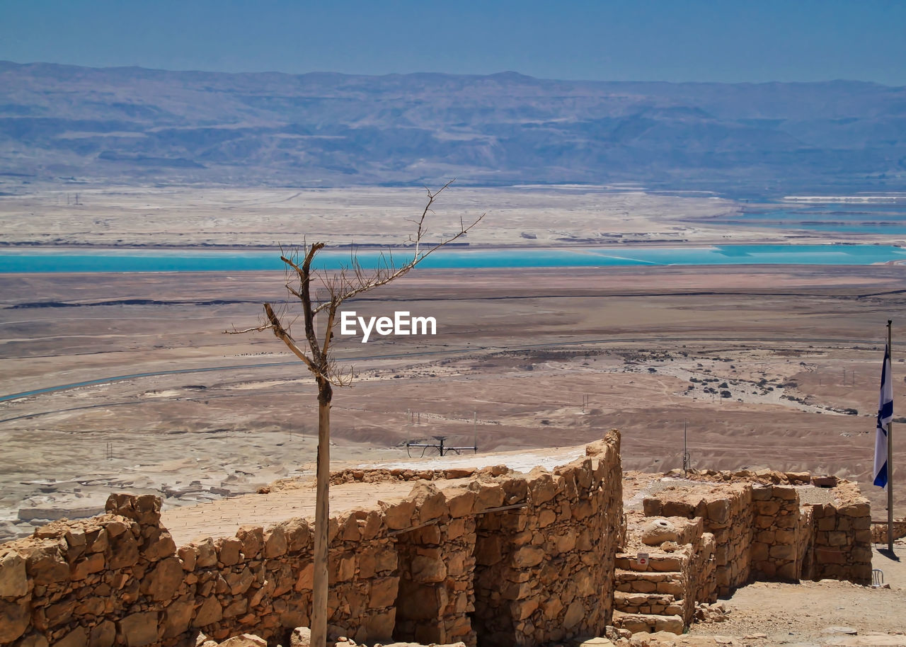 SCENIC VIEW OF SEA AGAINST MOUNTAINS