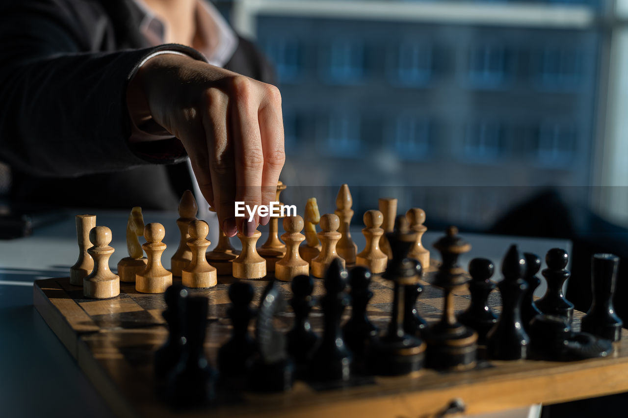 Woman playing on chess at home