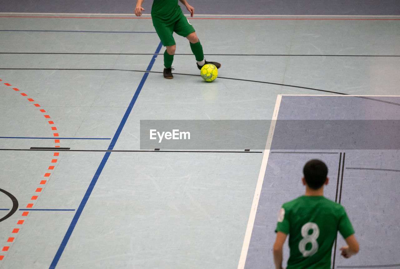 high angle view of man playing soccer at home