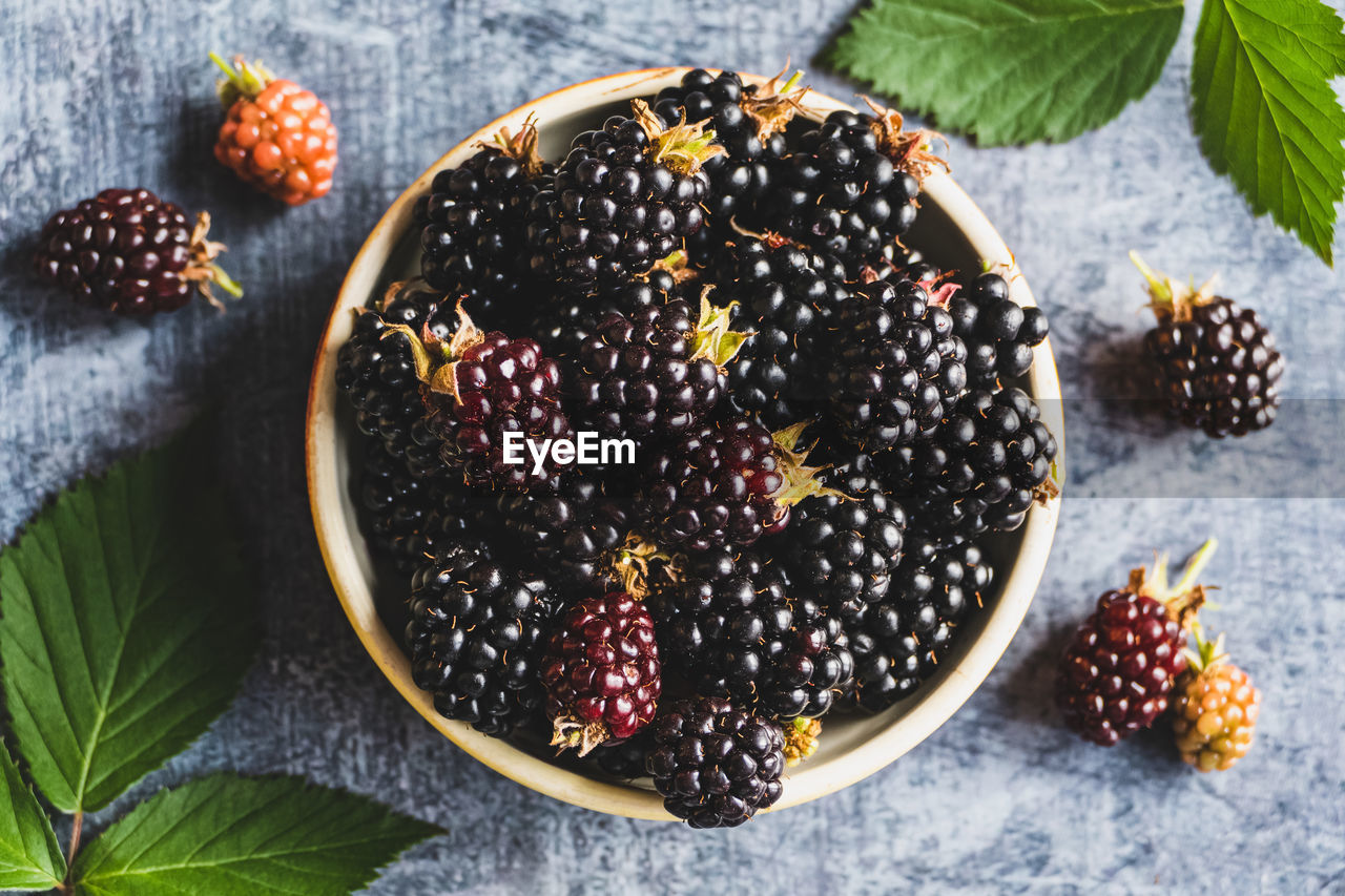 Blackberry fruits on in a bowl, food background, ripe blackberries closeup