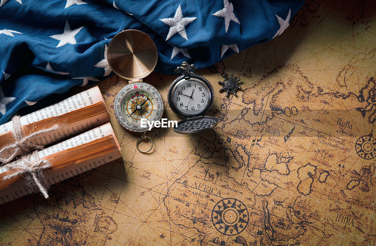 HIGH ANGLE VIEW OF CLOCK ON TABLE AT HOME