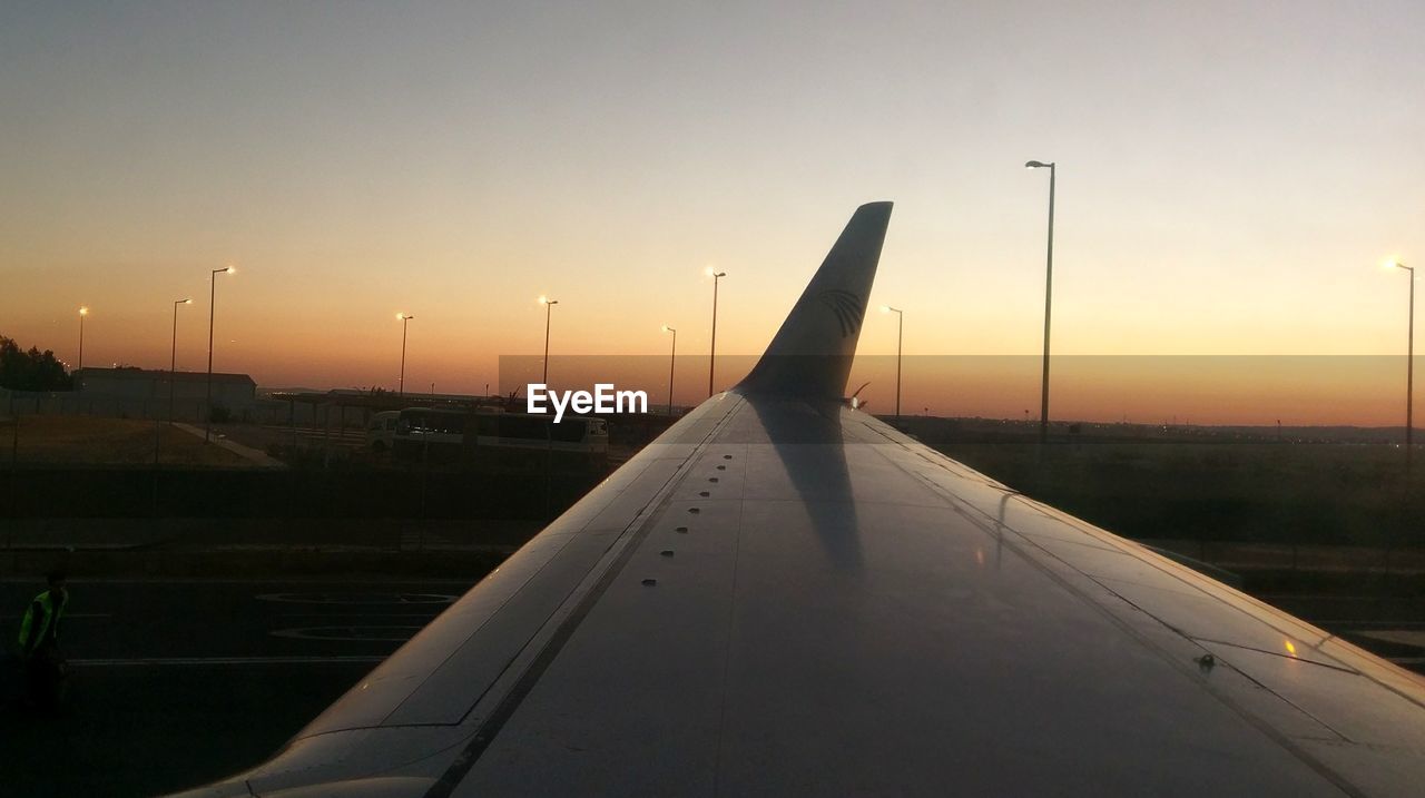 CLOSE-UP OF AIRPLANE ON RUNWAY AGAINST SKY