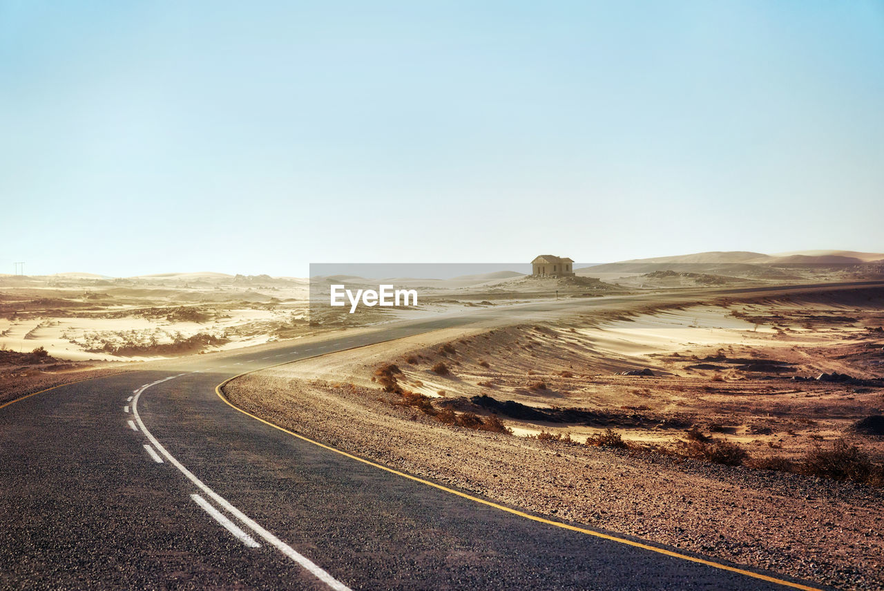 Road amidst landscape against clear sky