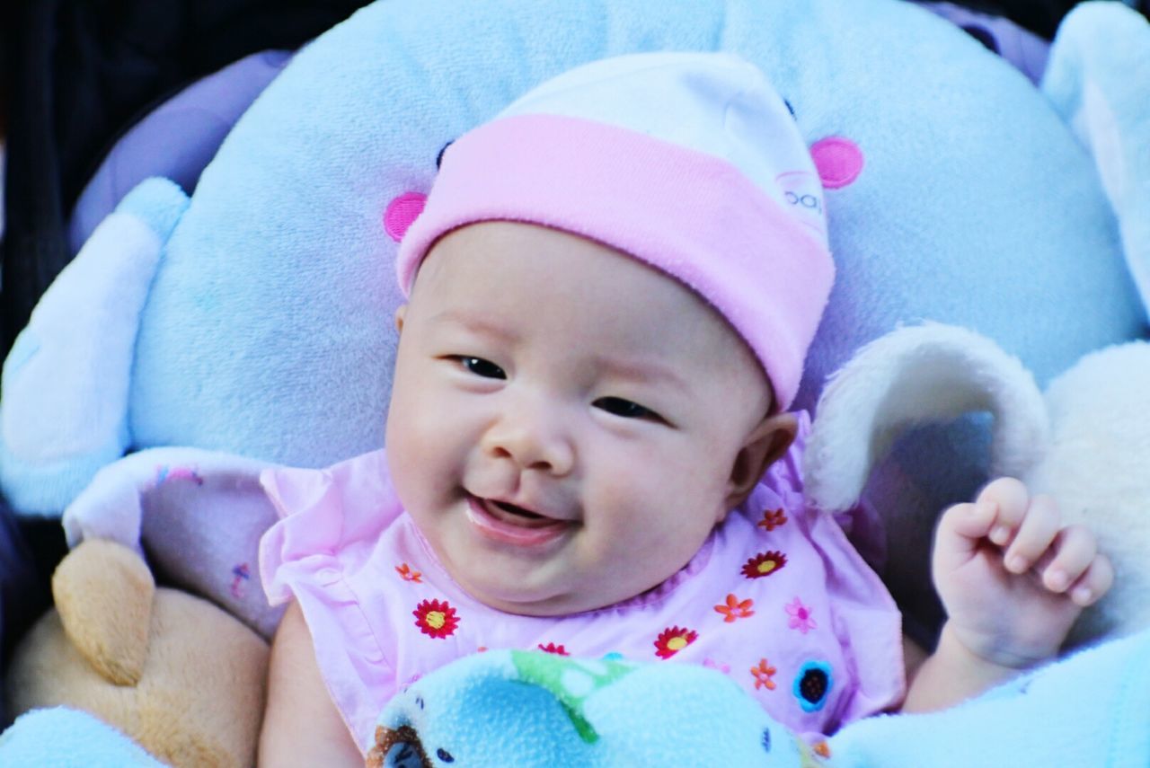 Close-up portrait of cute baby wearing knit hat