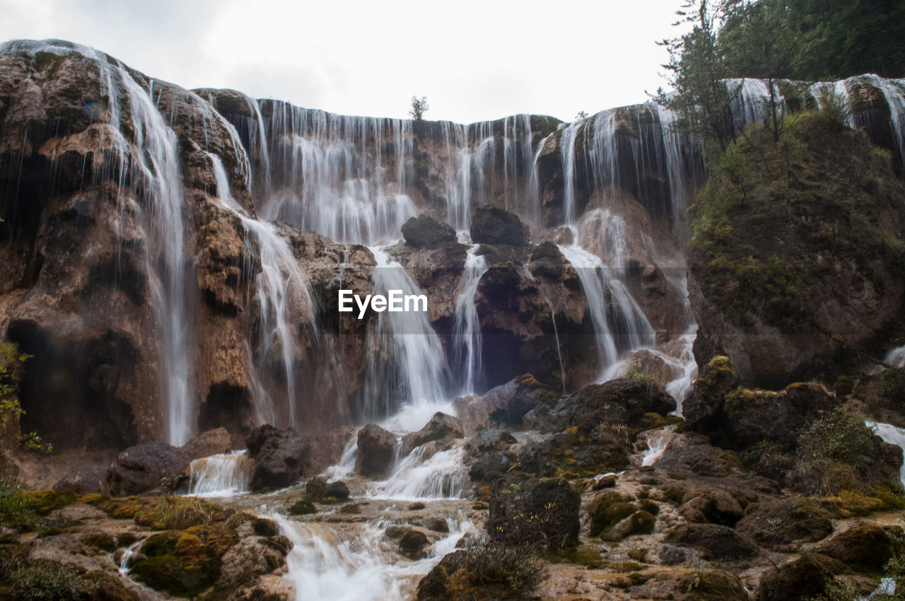 WATERFALL ALONG ROCKS