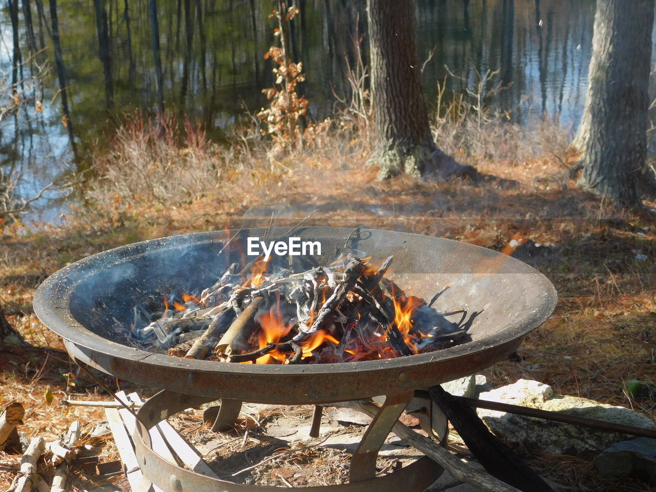 High angle view of bonfire  in firepit overlooking lake