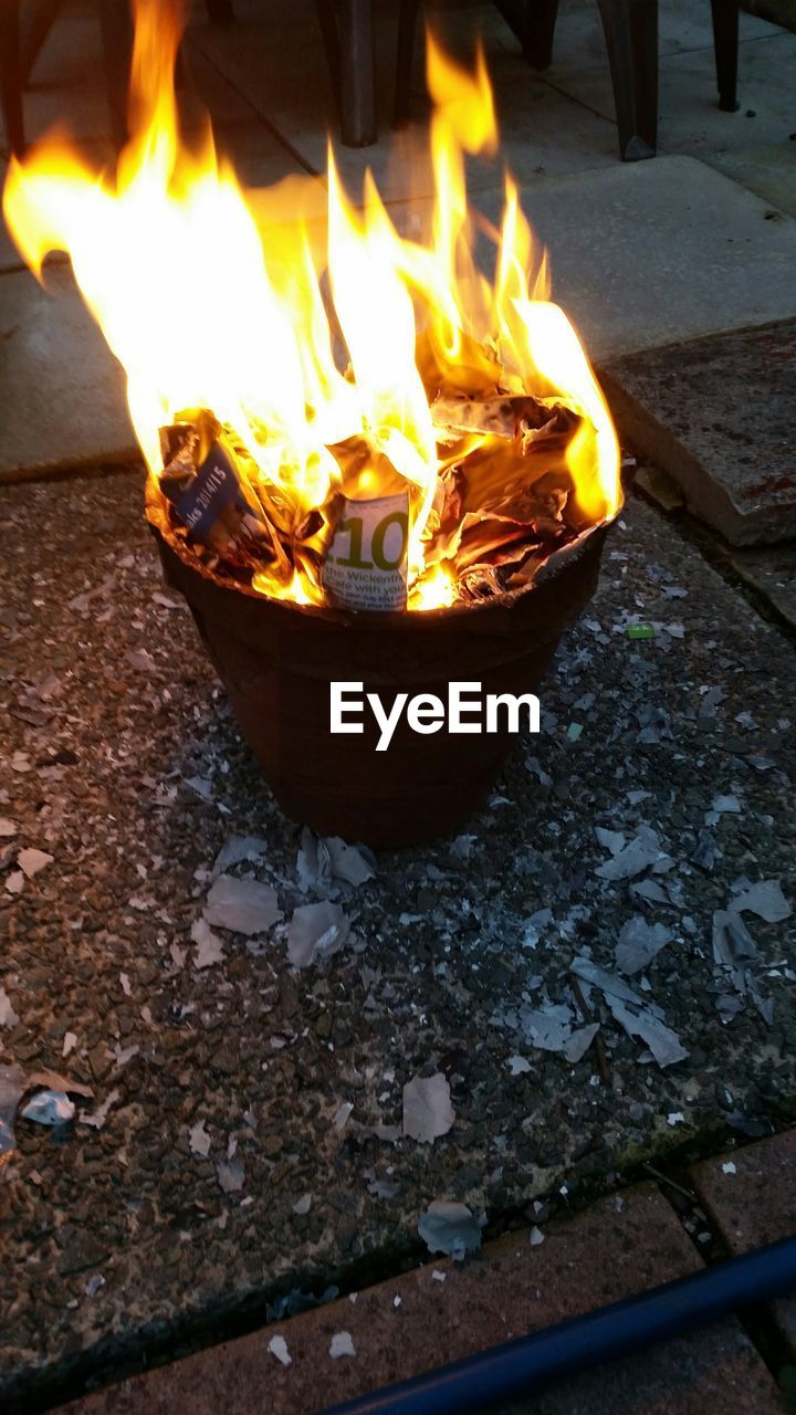 High angle view of burning papers in flower pot