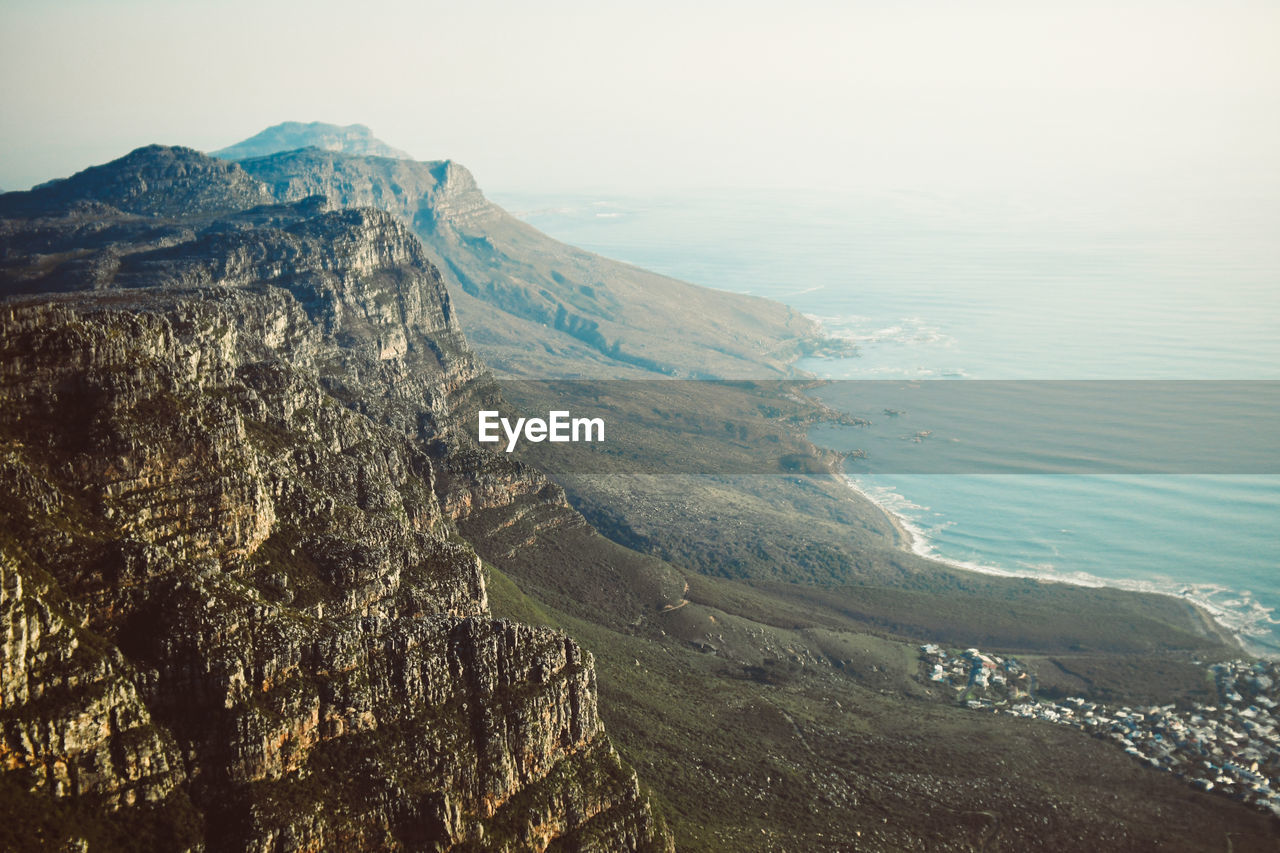 HIGH ANGLE VIEW OF SEA AND MOUNTAIN RANGE AGAINST SKY