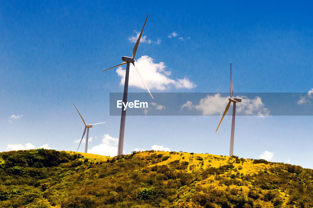 WINDMILL ON FIELD AGAINST SKY