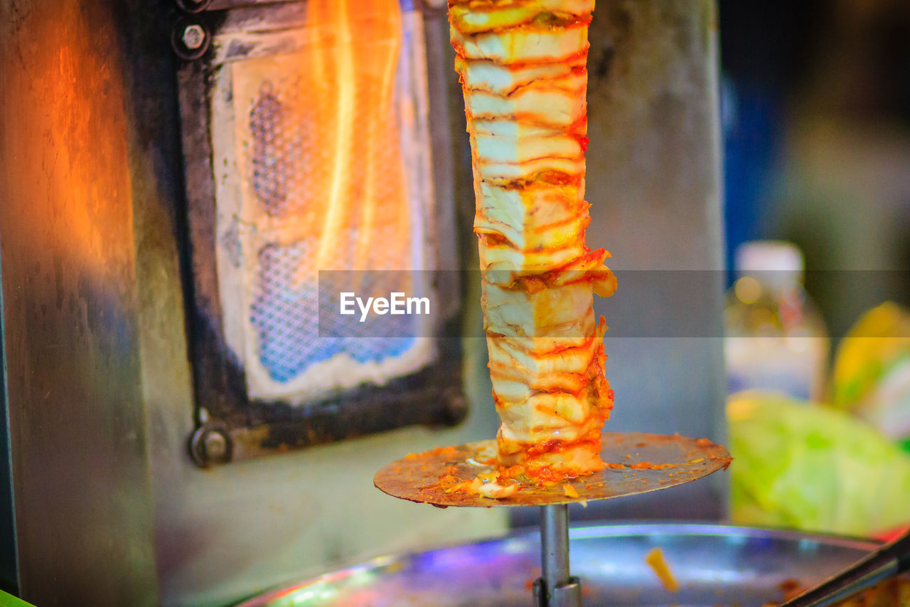 CLOSE-UP OF MEAT ON GRILL