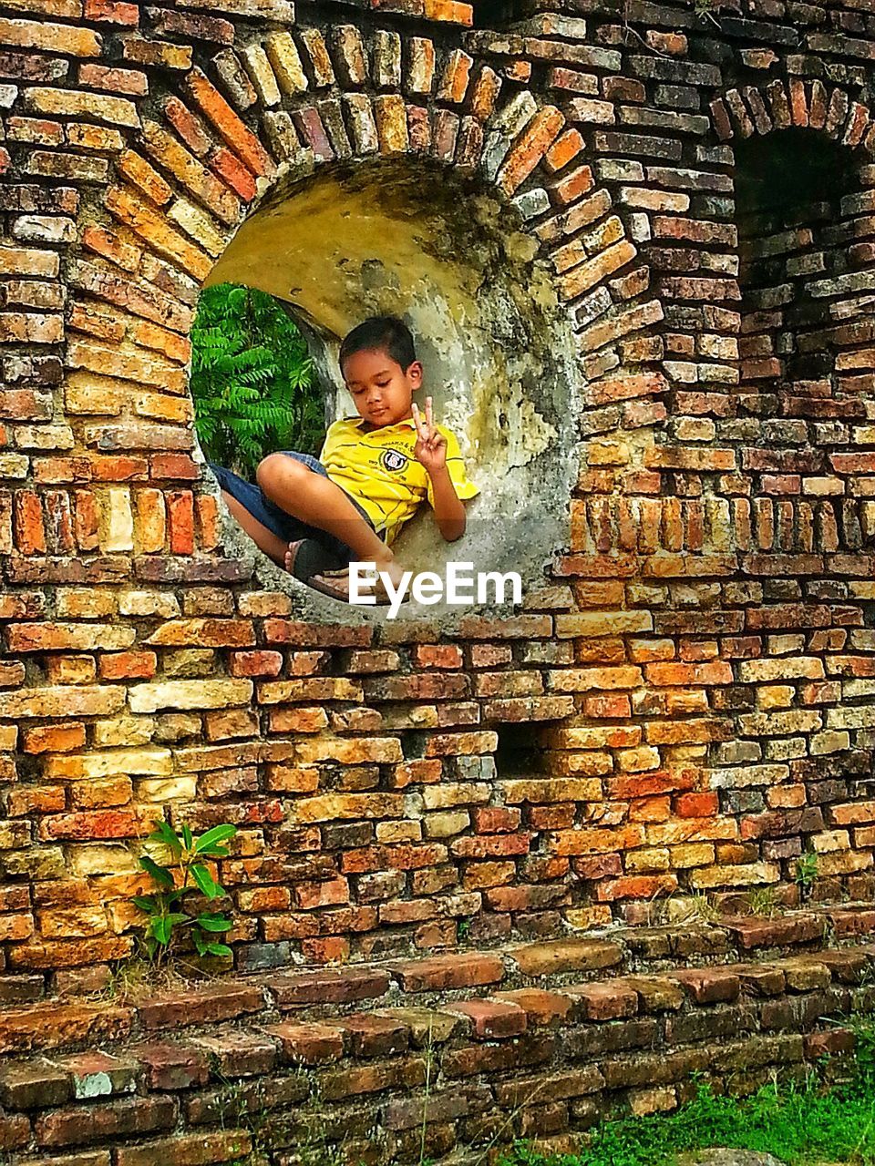 FULL LENGTH PORTRAIT OF BOY PLAYING IN STONE