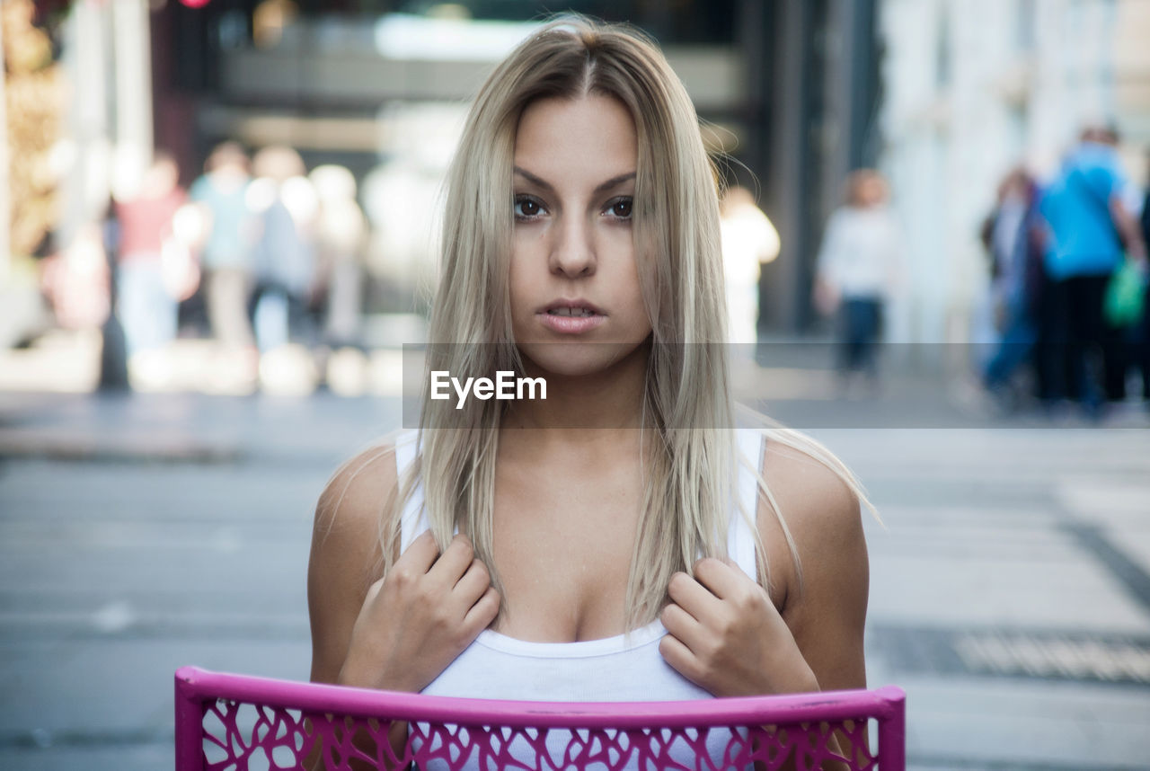 Close-up of beautiful young woman sitting on chair