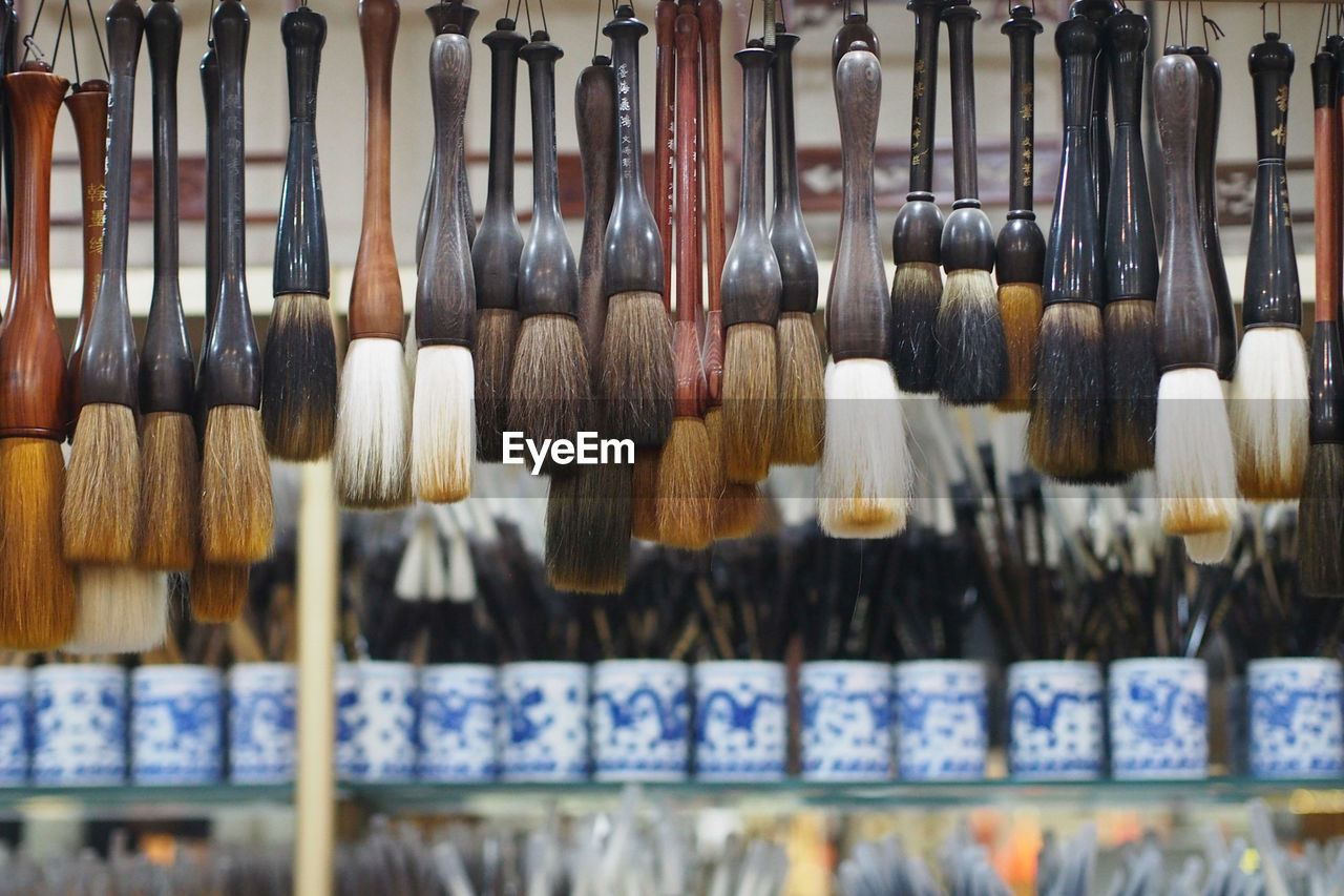 Brushes hanging in market for sale