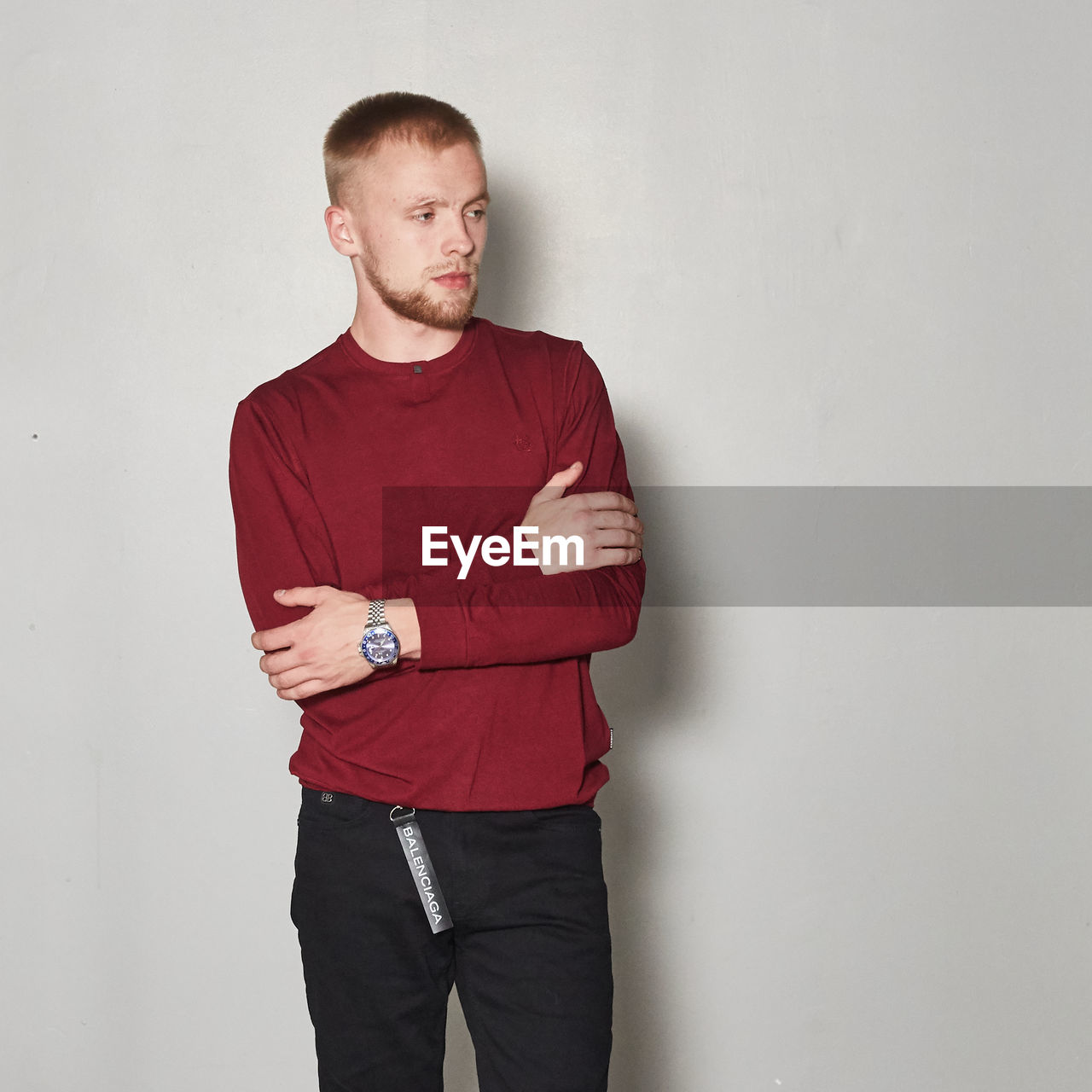 PORTRAIT OF MAN STANDING AGAINST WALL