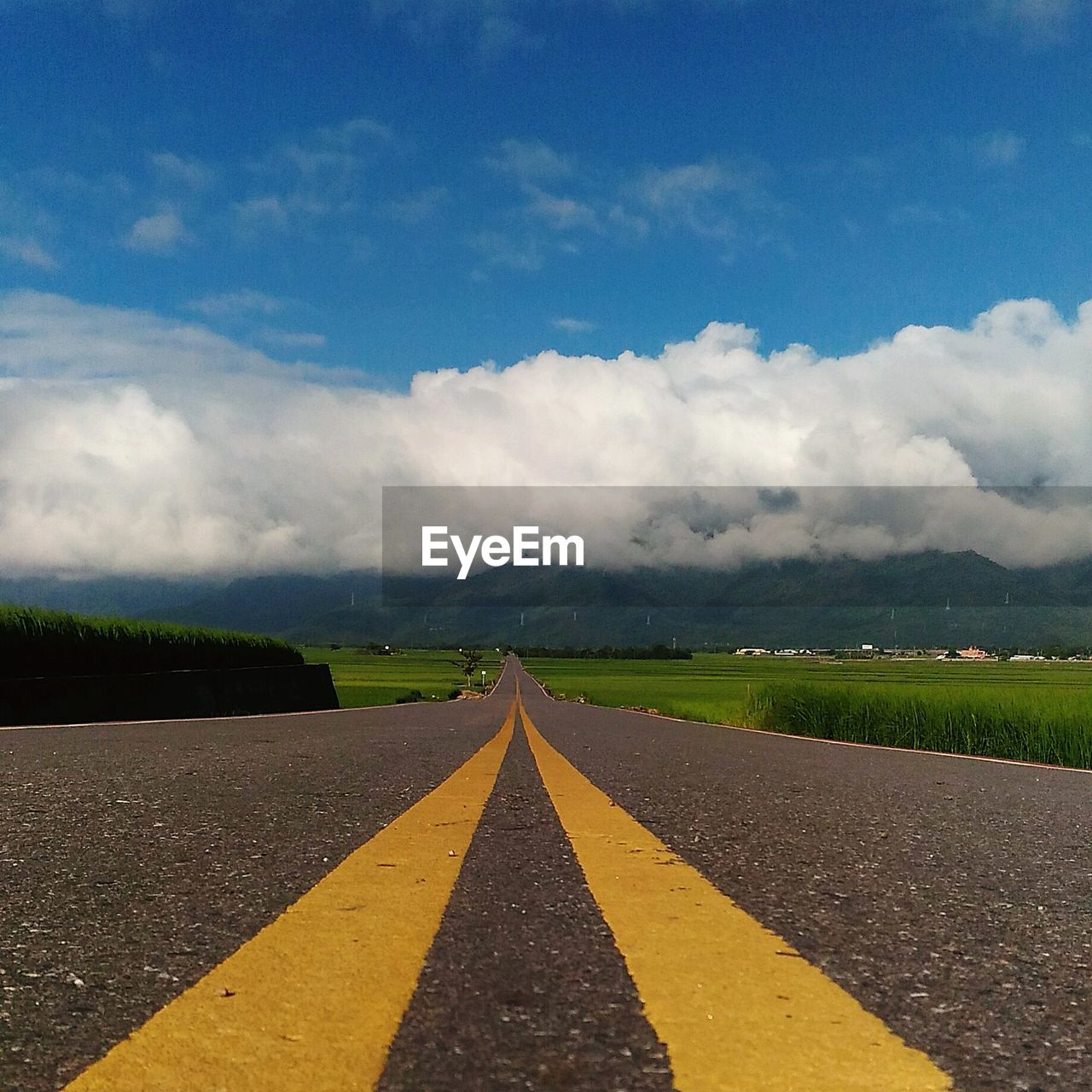 Road amidst landscape against sky