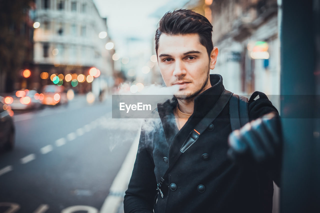 Portrait of man smoking cigarette