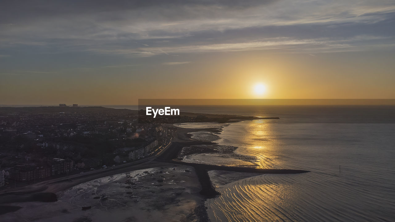 An aerial view of the sun setting over morecambe in lancashire, uk
