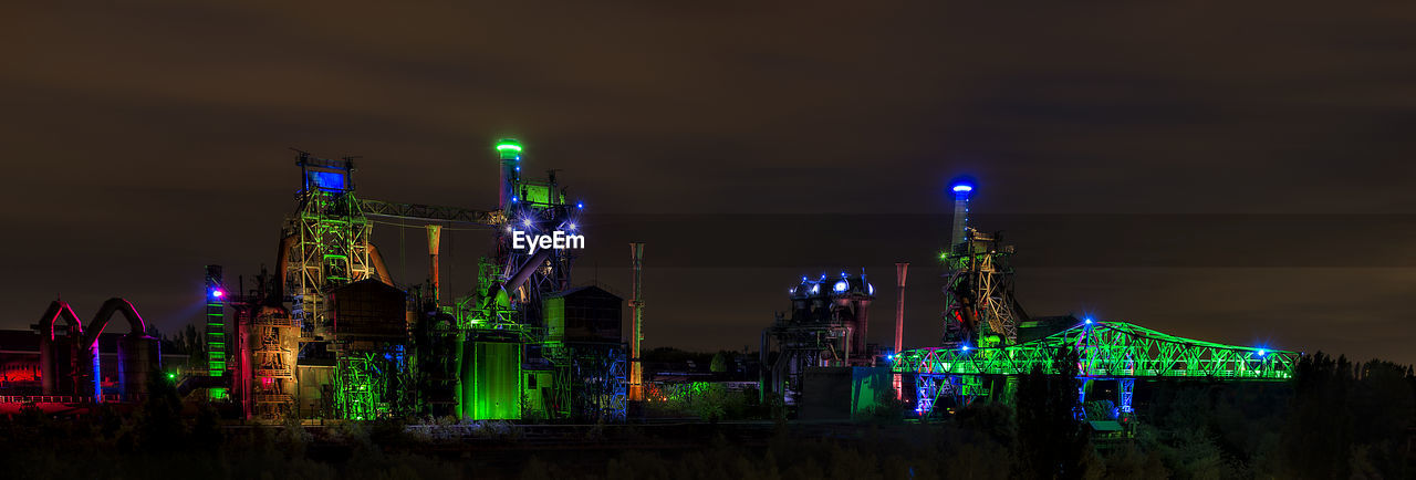 Illuminated modern buildings in city at night