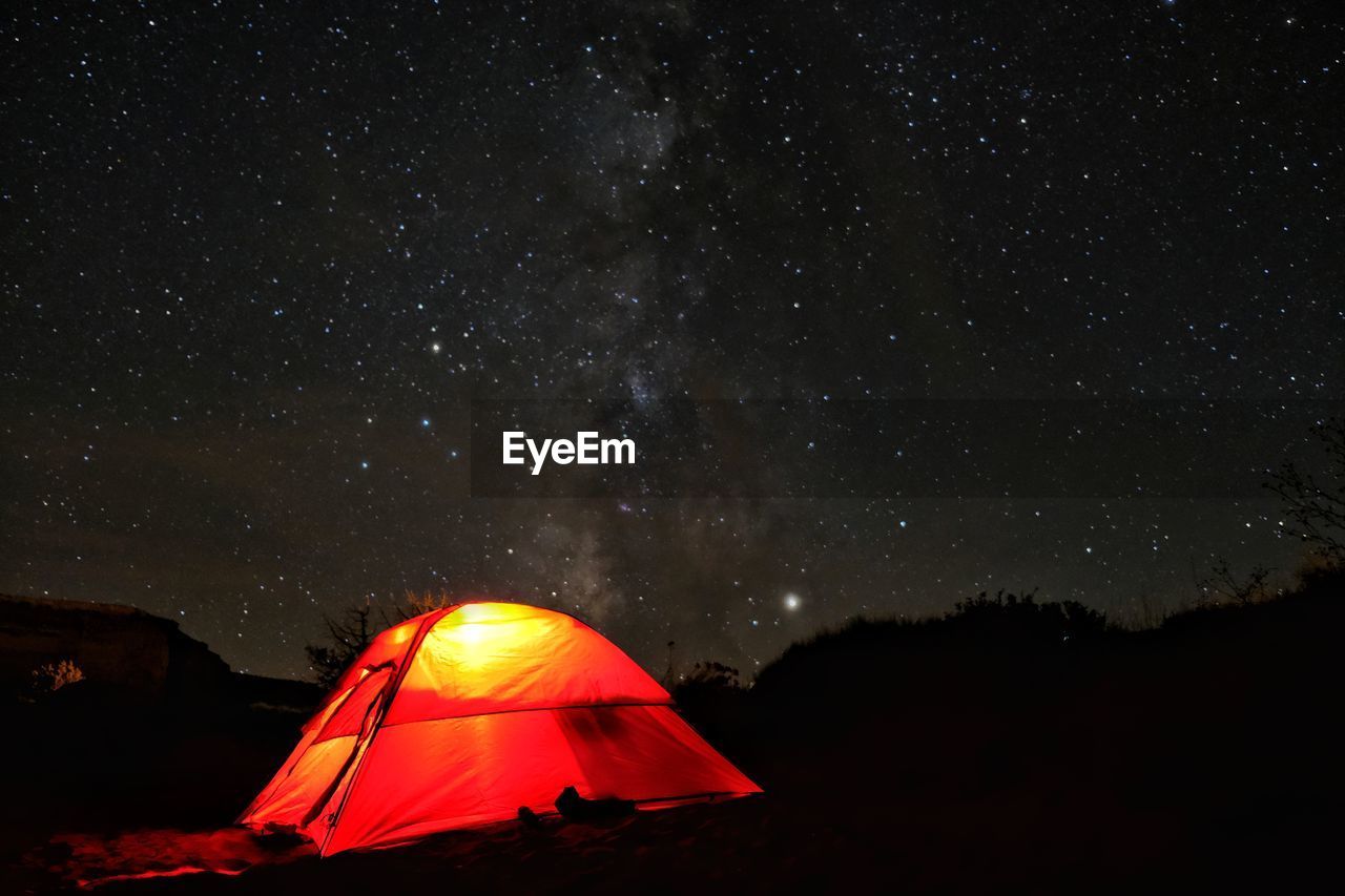 Tent on field against sky at night