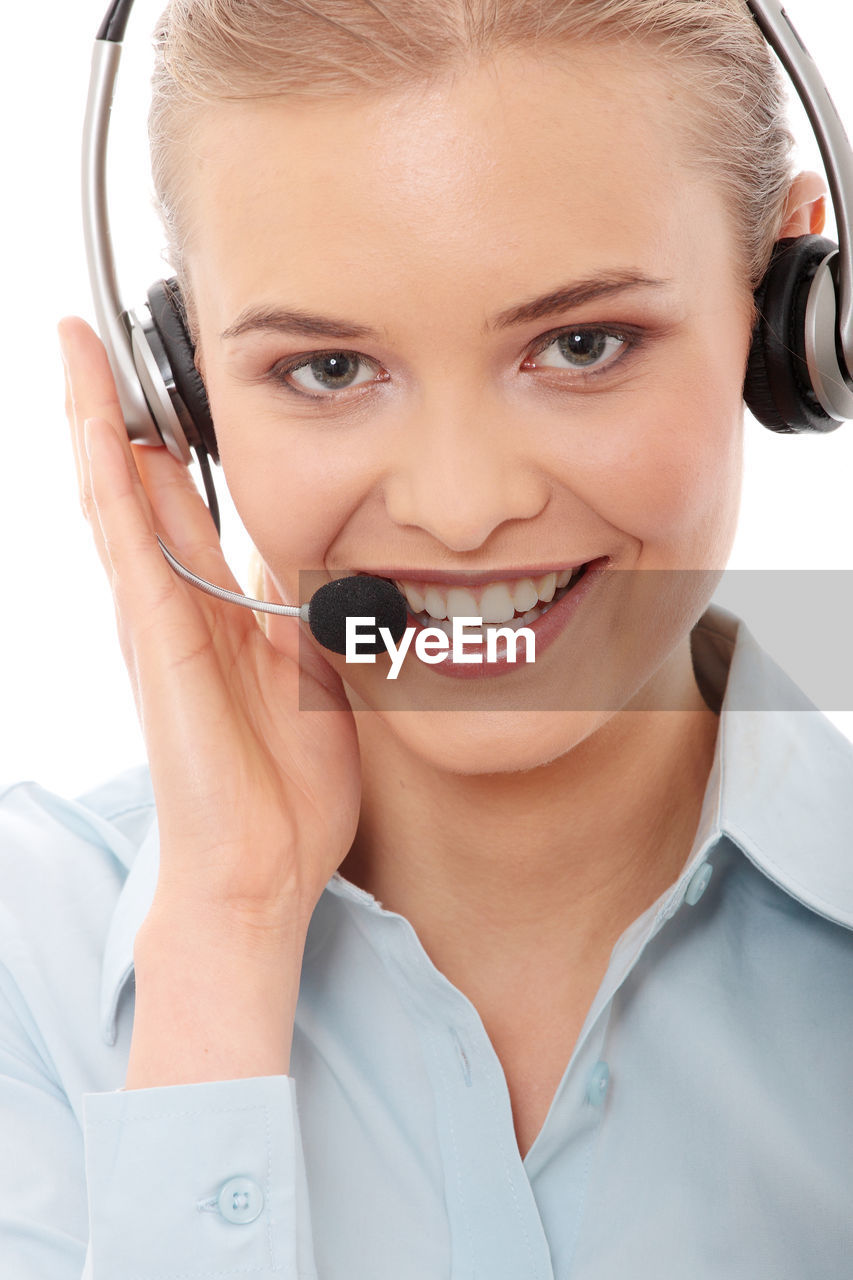 Portrait of customer service representative with headset against white background
