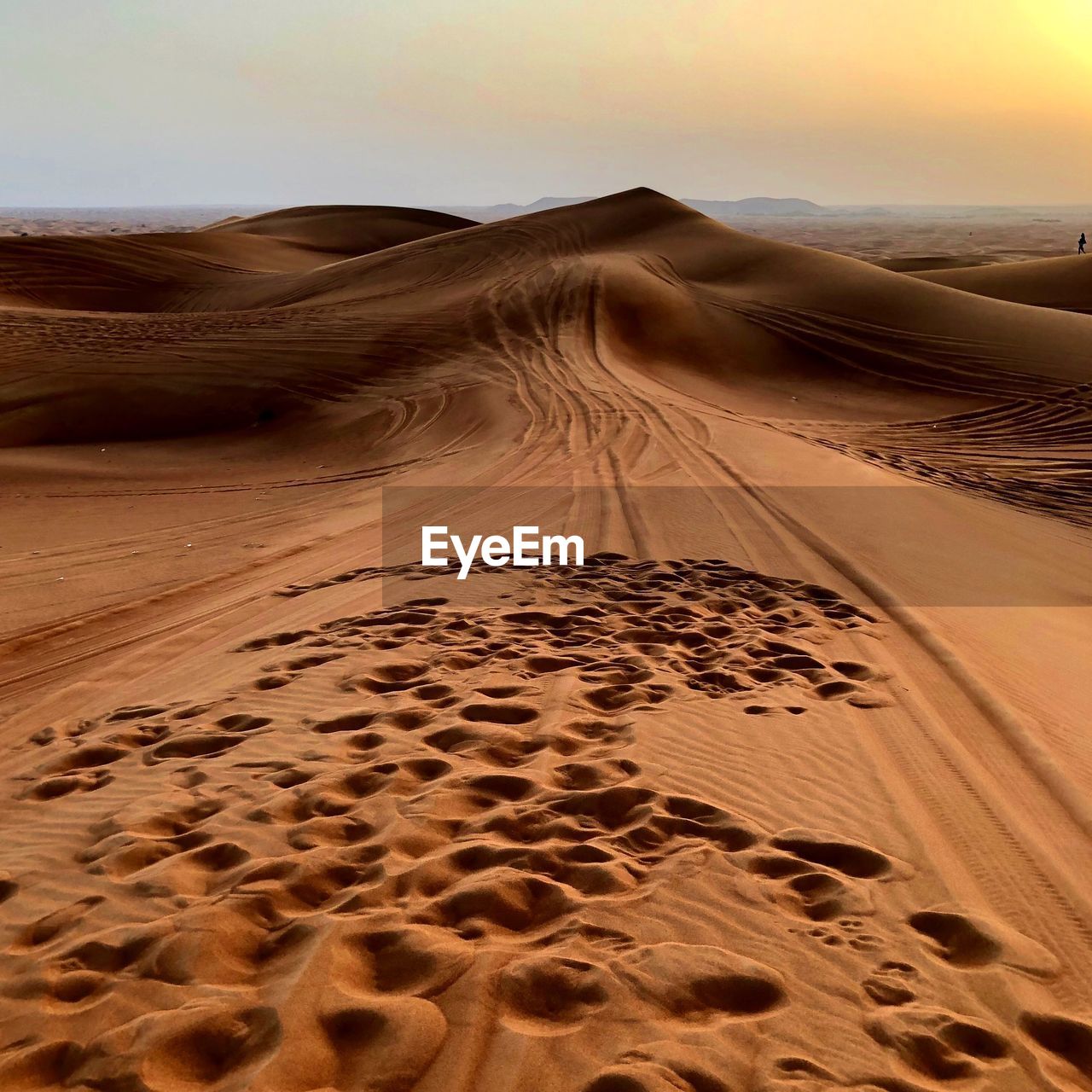 Sand dunes in desert against sky