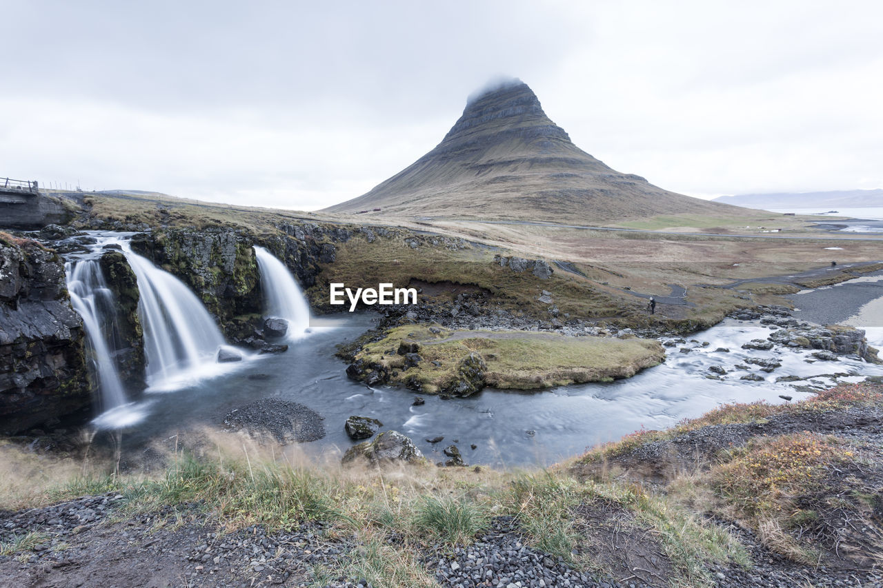 VIEW OF WATERFALL AGAINST SKY