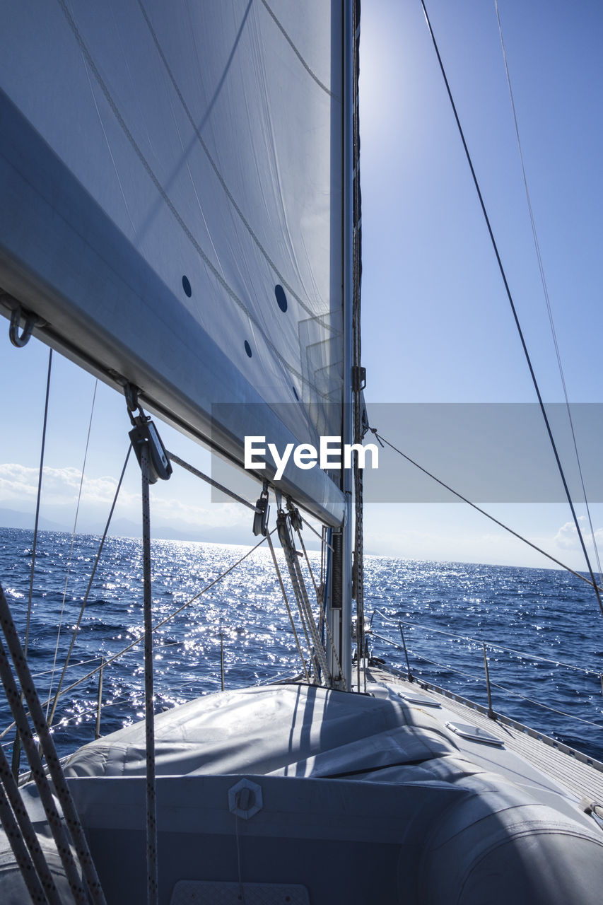 Sailboat sailing on sea against sky