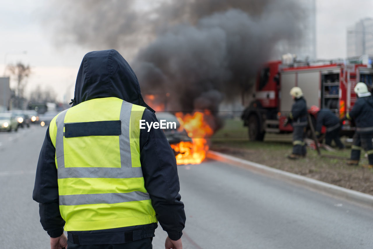 Rear view of firefighter on street