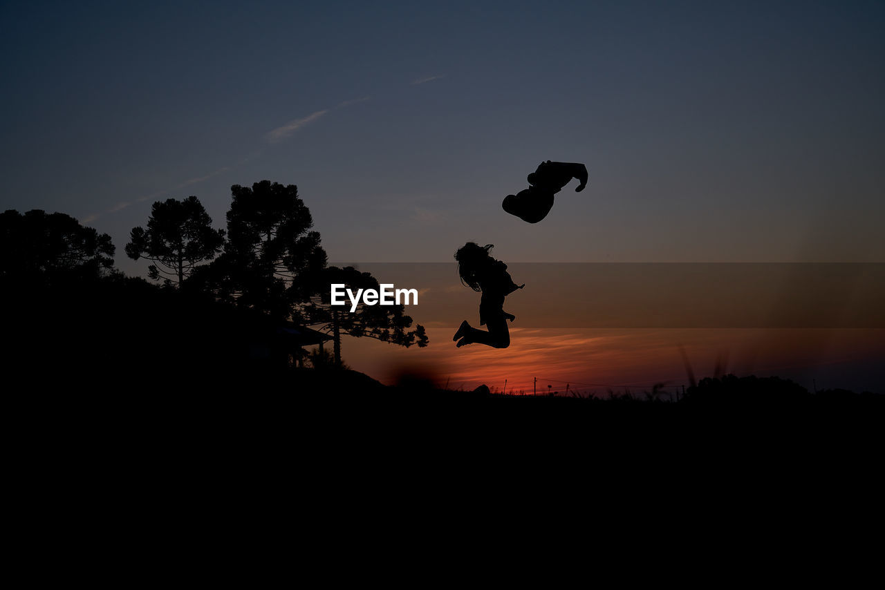 SILHOUETTE MAN JUMPING AGAINST SKY