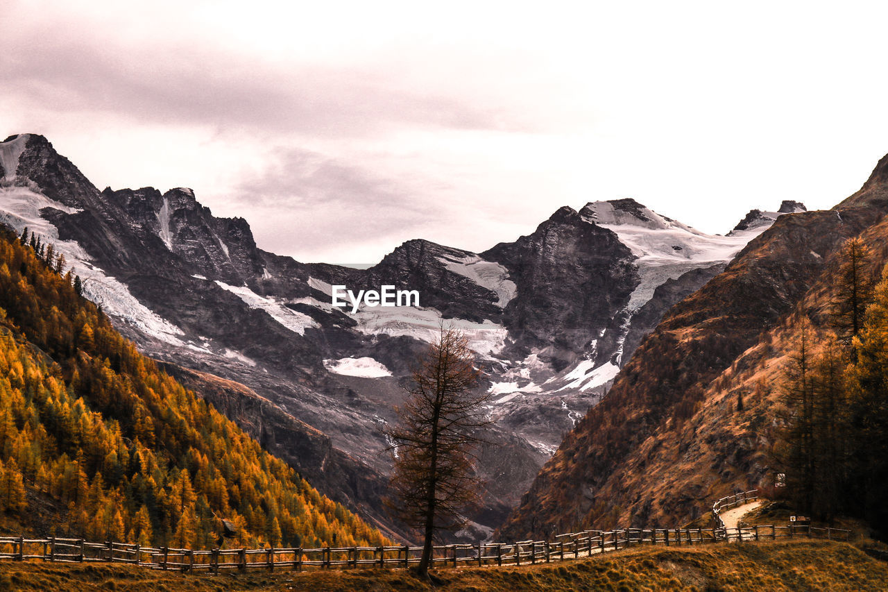 mountain, scenics - nature, environment, landscape, nature, mountain range, beauty in nature, sky, snow, cloud, wilderness, cold temperature, land, winter, travel destinations, travel, valley, no people, snowcapped mountain, mountain peak, tranquility, outdoors, tranquil scene, tourism, tree, plant, activity, non-urban scene, forest, coniferous tree, pinaceae, rock, pine tree, idyllic, pine woodland, vacation, autumn, plateau, leisure activity, trip, day, water, rural scene, ridge