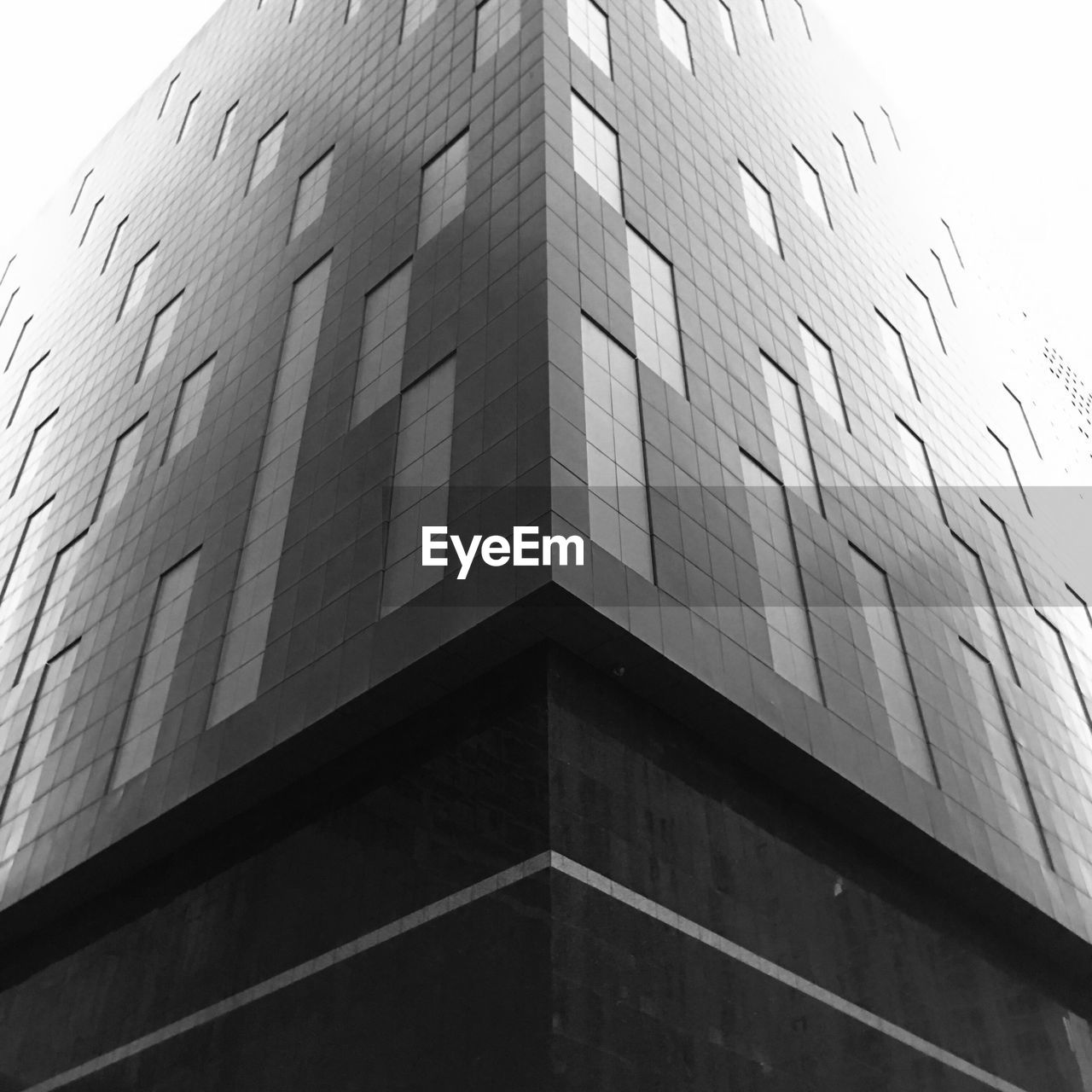 LOW ANGLE VIEW OF BRICK WALL WITH BUILDING