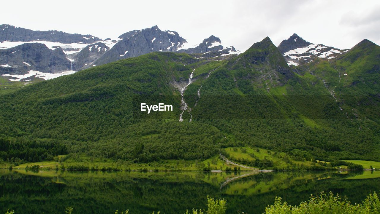 Scenic view of landscape and mountains against sky