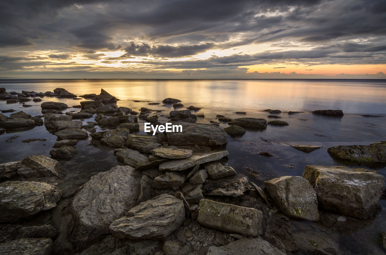 Scenic view of sea against sky at sunset