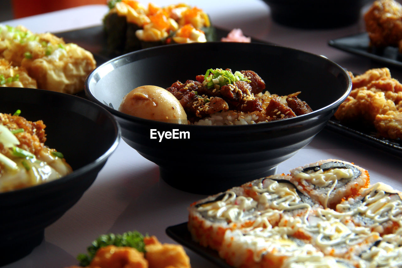 Photo of freshly made assorted japanese food on a table.