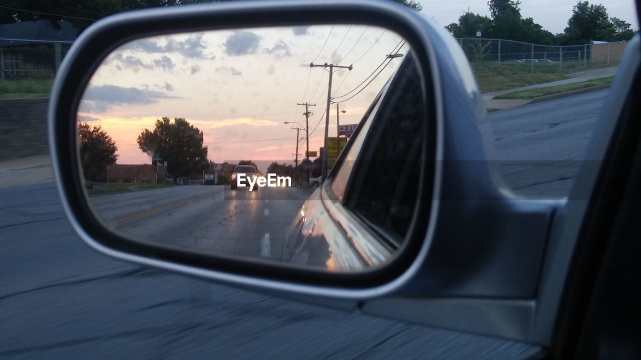 REFLECTION OF ROAD ON SIDE-VIEW MIRROR