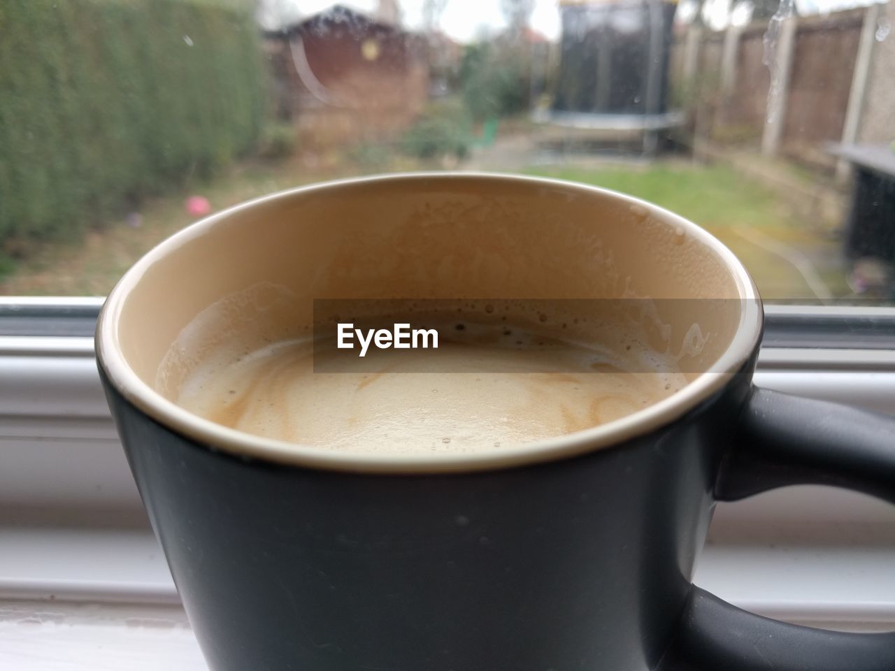 CLOSE-UP OF COFFEE CUP ON TABLE