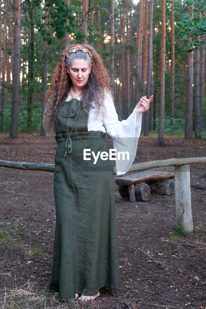 Woman standing in the woods