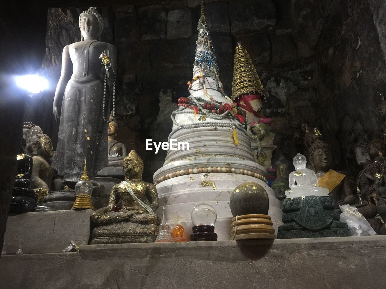 LOW ANGLE VIEW OF BUDDHA STATUE AGAINST CATHEDRAL