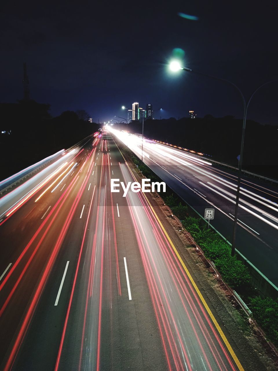 High angle view of light trails on highway at night