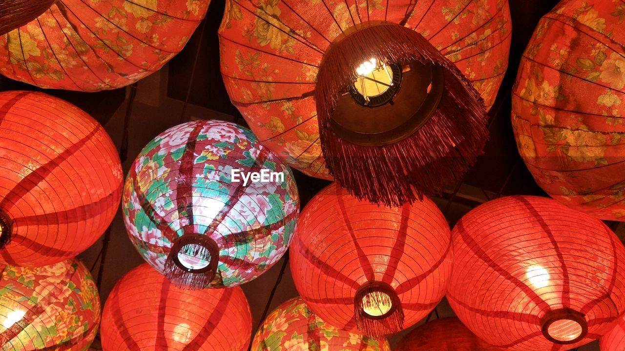 Low angle view of illuminated lanterns hanging at night