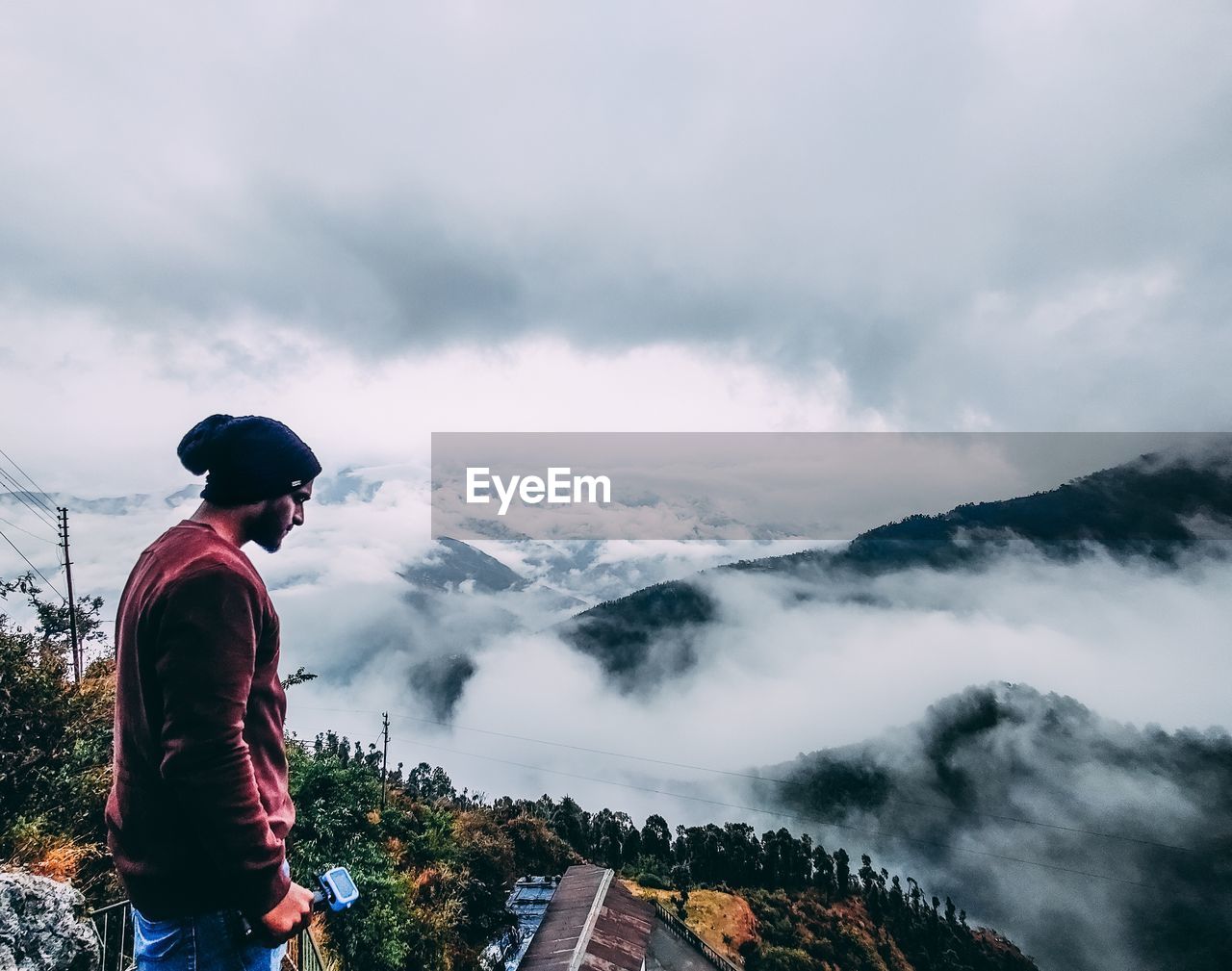 MAN STANDING AGAINST MOUNTAIN