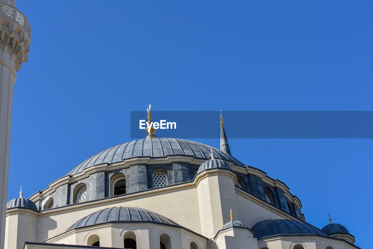 Low angle view of building against clear blue sky