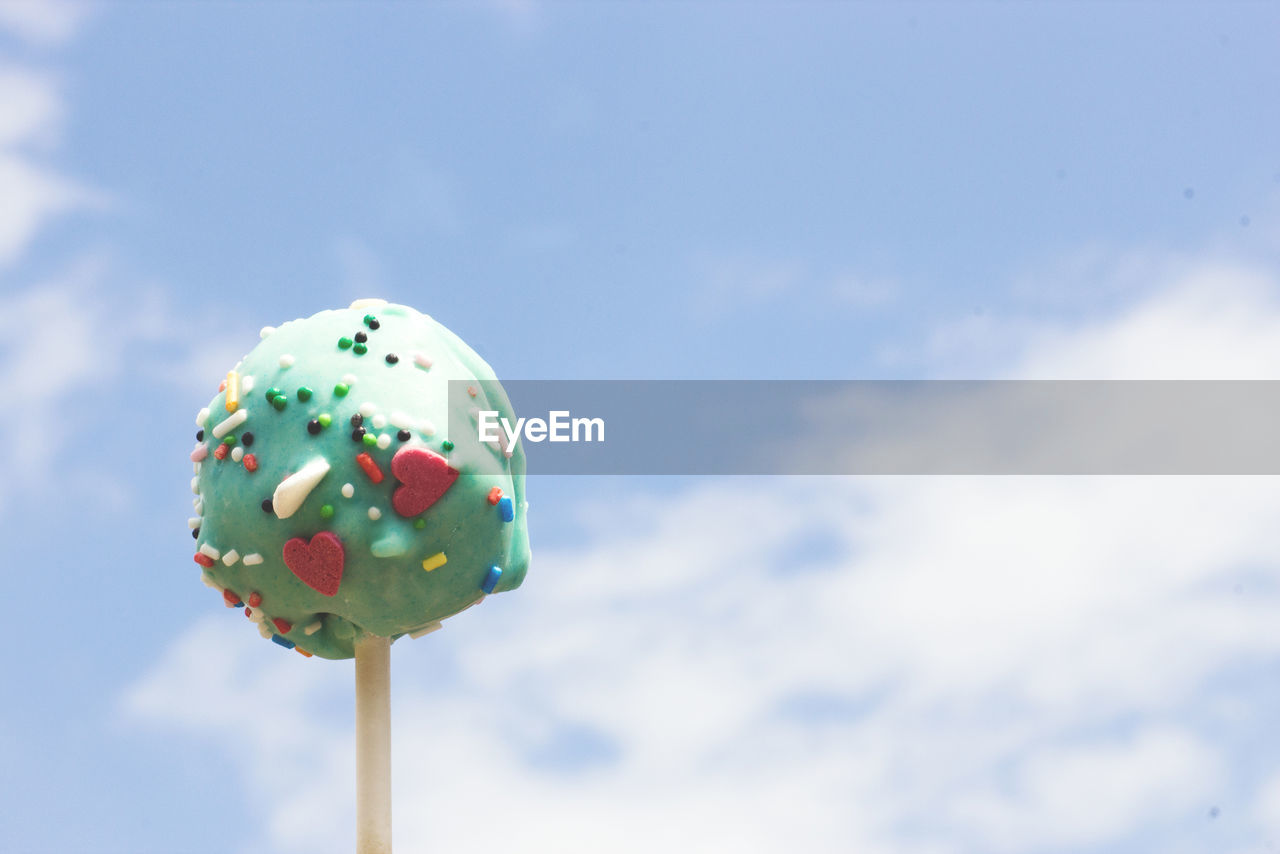 Close-up of lollipop against sky